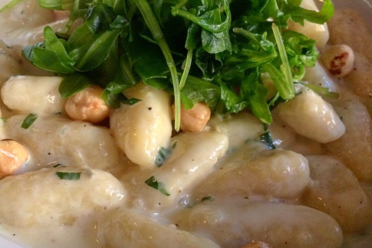 ultra-light potato gnocchi in a rich gorgonzola cream sauce with hazelnuts